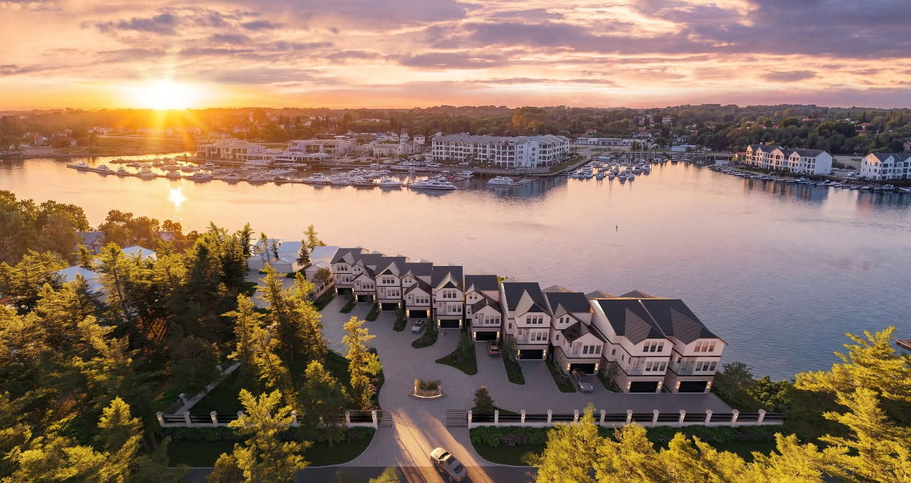 Front elevation of townhomes featuring private pool and outdoor living spaces